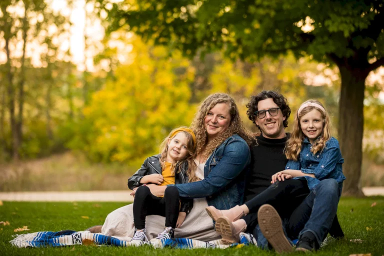 A seated family portrait at Woodbine Beach Toronto