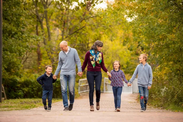 autumn family photography at Todmorden Mills Toronto. Family walking on cobble path