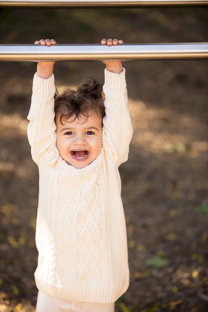 girl swinging at a playground family photo