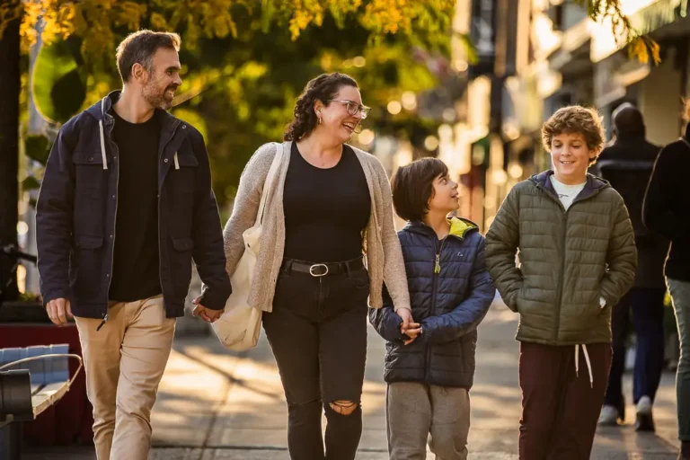 Candid photo of a family strolling down the Danforth during a relaxed fall photo session