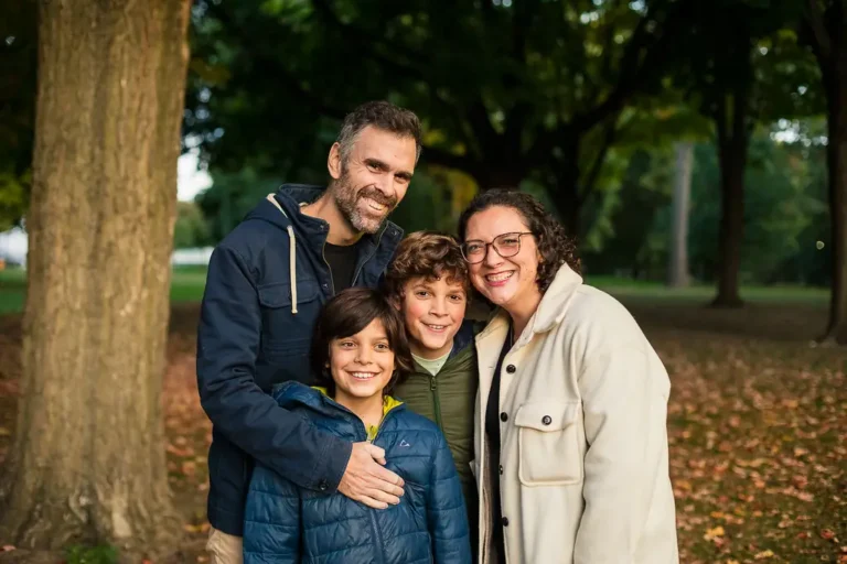 Warm family portraits in Monarch Park with autumn leaves and golden hour light
