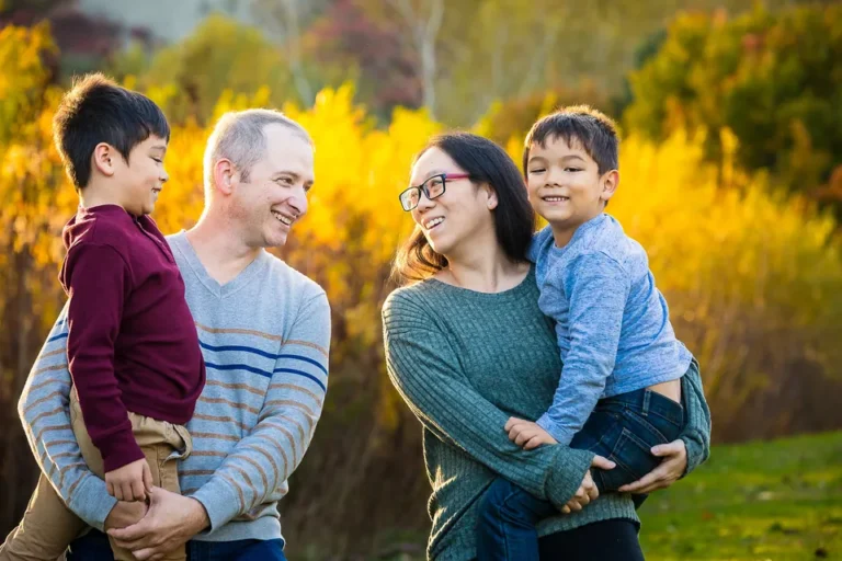 Family smiling in the golden light at the Scarborough Bluffs