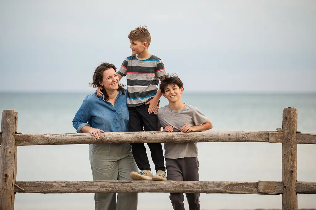 simple family portrait on the beach with lake in background. Toronto beaches