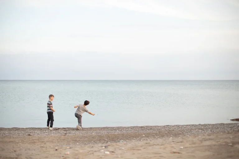 boys skipping stones, minimal family photo at The Beaches Toronto